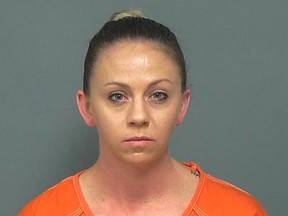 FILE - This file photo provided by the Mesquite Police Department shows Amber Guyger, taken Friday, Nov. 30, 2018. The former Dallas police officer who fatally shot an unarmed black man in his own home told a 911 dispatcher "I thought it was my apartment" nearly 20 times as she waited for emergency responders to arrive. That's according to a 911 recording obtained by Dallas TV station WFAA. Guyger is charged in the September 2018 killing of Botham Jean. (Mesquite Police Department via AP)