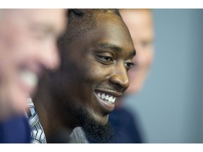 Dallas Cowboys defensive end Demarcus Lawrence, center, laughs during a press conference at The Star in Frisco, Texas, Tuesday, April 9, 2019. DeMarcus Lawrence may not be the highest-paid Dallas Cowboys player in history for long. It doesn't mean the club's best defensive end can't enjoy the distinction while it lasts. The 26-year-old Lawrence signed a $105 million, five-year contract Tuesday.