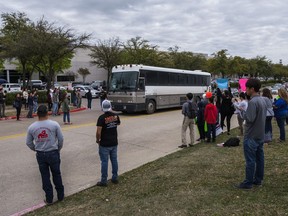 In this Wednesday, April 3, 2019 photo, a bus from LaSalle Corrections Transport departs CVE Group in Allen, Texas. Immigration agents arrested nearly 300 people at the North Texas technology company in what authorities say is one of the largest enforcement actions of its kind in a decade