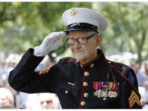 In a May 30, 2016 photo, U.S. Marine veteran R. V. Burgin, 93, salutes during the 76th Annual Memorial Day Service at Restland Memorial Park in Dallas. Burgin, whose book about grueling jungle combat during WWII became a basis for the HBO miniseries "The Pacific" died April 6, 2019 at his home in Texas. He was 96.