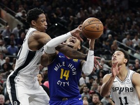 Denver Nuggets guard Gary Harris (14) is fouled by San Antonio Spurs guard DeMar DeRozan (10) during the first half of Game 6 of an NBA basketball playoff series, Thursday, April 25, 2019, in San Antonio.