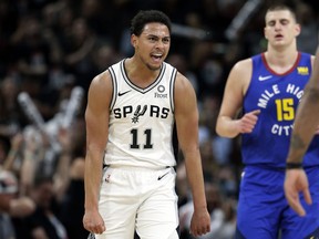 San Antonio Spurs guard Bryn Forbes (11) reacts after scoring against the Denver Nuggets during the first half of Game 3 of an NBA basketball playoff series in San Antonio, Thursday, April 18, 2019.