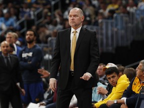 Denver Nuggets head coach Michael Malone watches in the first half of Game 5 of an NBA basketball first round playoff series against the San Antonio Spurs, Tuesday, April 23, 2019, in Denver.