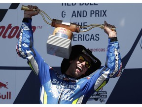 CORRECTS TO RINS OF SPAIN NOT AUSTRALIA = Alex Rins, of Spain, celebrates with his trophy after winning the Grand Prix of the Americas motorcycle race at the Circuit of the Americas, Sunday, April 14, 2019, in Austin, Texas.