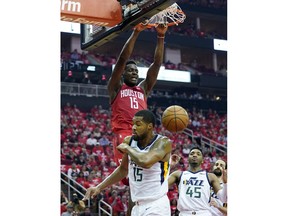 Houston Rockets center Clint Capela (15) scores over Utah Jazz forward Derrick Favors (15) during the first half in Game 5 of an NBA basketball playoff series, in Houston, Wednesday, April 24, 2019.