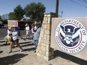 FILE - This June 2018 file photo shows protesters walking along Montana Avenue outside the El Paso Processing Center, in El Paso, Texas. On Tuesday, April 23, 2019, a U.S. government watchdog agency said they have launched an investigation in the wake of an Associated Press report revealing complaints about how immigration authorities treated hunger strikers at this facility.