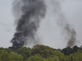 A plume of smoke rises over the site of a fire at the KMCO plant Tuesday, April 2, 2019, in Crosby, northeast of Houston, Texas. A tank holding a flammable chemical caught fire at the Texas plant Tuesday. Harris County Sheriff Ed Gonzalez confirmed fatality in a tweet and said injured ones had been taken by helicopter to a hospital.