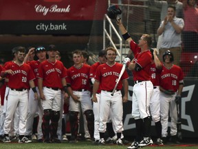 Texas Tech's Josh Jung, right foreground, waves to the bullpen after hitting a home run during an NCAA college baseball game against Oklahoma State in Lubbock, Texas, Saturday, April 27, 2019. Texas Tech is finding its groove just in time for the home stretch of the regular season. The Red Raiders, who had a losing record in Big 12 play less than two weeks ago, are 1 1-2 games behind first-place Baylor after a weekend sweep against an Oklahoma State team that came in leading the league.