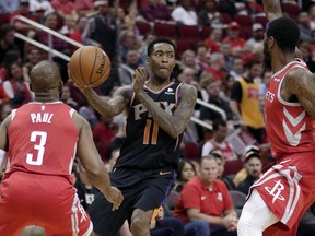 Phoenix Suns guard Jamal Crawford (11) looks to pass the ball between Houston Rockets guards Chris Paul (3) and Iman Shumpert, right, during the first half of an NBA basketball game Sunday, April 7, 2019, in Houston.