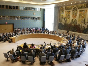Members of the Security Council vote on a resolution concerning sexual violence during a Security Council meeting at United Nations headquarters, Tuesday, April 23, 2019.
