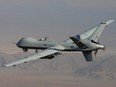 In this undated handout file photo provided by the U.S. Air Force, an MQ-9 Reaper, armed with GBU-12 Paveway II laser-guided munitions and AGM-114 Hellfire missiles is piloted by Col. Lex Turner during a combat mission over southern Afghanistan.
