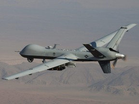 In this undated handout file photo provided by the U.S. Air Force, an MQ-9 Reaper, armed with GBU-12 Paveway II laser-guided munitions and AGM-114 Hellfire missiles is piloted by Col. Lex Turner during a combat mission over southern Afghanistan.