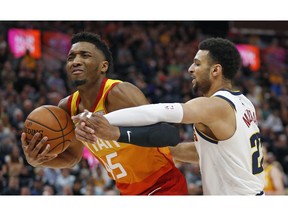 Denver Nuggets guard Jamal Murray, right, defends against Utah Jazz guard Donovan Mitchell (45) in the first half during an NBA basketball game Tuesday, April 9, 2019, in Salt Lake City.