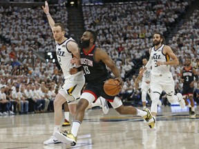 Houston Rockets guard James Harden (13) drives against Utah Jazz forward Joe Ingles (2) in the first half during Game 4 of a first-round NBA basketball playoff series Monday, April 22, 2019, in Salt Lake City.