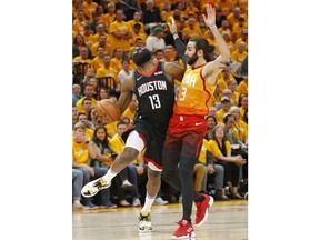 Utah Jazz guard Ricky Rubio (3) fouls Houston Rockets guard James Harden (13) as he drives in the first half during an NBA basketball game Saturday, April 20, 2019, in Salt Lake City.