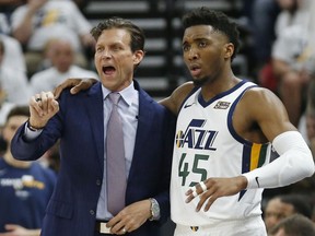 Utah Jazz head coach Quin Snyder and guard Donovan Mitchell (45) speak in the first half during Game 4 of a first-round NBA basketball playoff series against the Houston Rockets, Monday, April 22, 2019, in Salt Lake City.