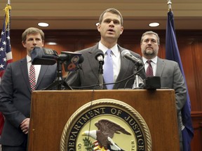 FILE - In this March 27, 2019, file photo, U.S. Attorney Thomas Cullen, center, speaks with the media in Charlottesville Federal Court in Charlottesville, Va. A member of a white supremacist group pleaded guilty Monday, April 29, to conspiring to riot at a white nationalist rally in Virginia and at other demonstrations in California.