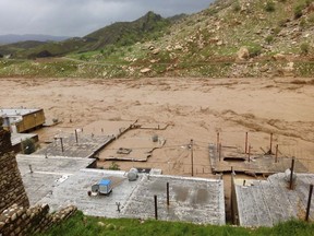 In this Monday, April 1, 2019 photo, houses are covered by floodwaters in the town of Mamoulan, in the western province of Lorestan, Iran. Iran's Foreign Minister Mohammad Javad Zarif tweeted late on Monday that U.S. sanctions imposed on Tehran by the Trump administration last year have hampered successful rescue efforts for flood-stricken areas of the country where 45 people have died so far. Iran has been facing major flooding for the past two weeks.