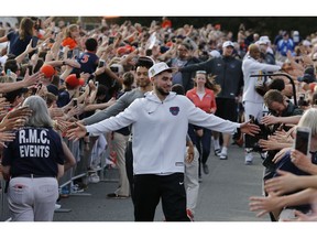 Ty Jerome and other members of the Virginia basketball team are welcomed by fans as they return home after their win of the championship in the Final Four NCAA college basketball tournament against Texas Tech, in Charlottesville, Va., Tuesday, April 9, 2019.