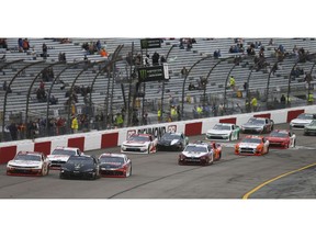 Riley Herbst (18) leads the field at the start of the NASCAR Xfinity Series auto race at Richmond Raceway in Richmond, Va., Friday, April 12, 2019.