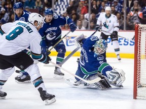 San Jose Sharks' Joe Pavelski (8) scores against Vancouver Canucks goalie Thatcher Demko during the first period of an NHL hockey game in Vancouver, on Tuesday April 2, 2019.