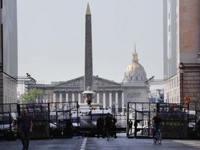 Police seal off an area around the Place de la Concorde prior to a yellow vest demonstration in Paris, Saturday, April 20, 2019. French yellow vest protesters are marching anew to remind the government that rebuilding the fire-ravaged Notre Dame Cathedral isn't the only problem the nation needs to solve.