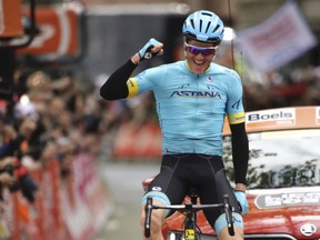 Denmark's Jakob Fuglsang from the Astana Pro team crosses the finish line to take first place in the Liege Bastogne Liege cycling race in Ans, Belgium on Sunday, April 28, 2019.