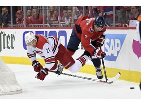 Carolina Hurricanes right wing Nino Niederreiter (21) falls to the ice next to Washington Capitals defenseman Matt Niskanen (2) during the first period of Game 2 of an NHL hockey first-round playoff series, Saturday, April 13, 2019, in Washington.