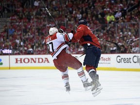 Washington Capitals left wing Alex Ovechkin (8), of Russia, collides with Carolina Hurricanes defenseman Justin Faulk (27) during the first period of Game 5 of an NHL hockey first-round playoff series, Saturday, April 20, 2019, in Washington.