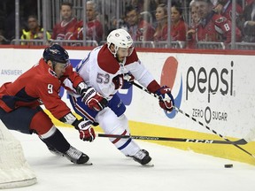 Washington Capitals defenseman Dmitry Orlov (9), of Russia, tries to take the puck from Montreal Canadiens defenseman Victor Mete (53) during the first period of their NHL hockey game in Washington, Thursday, April 4, 2019.