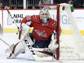 Washington Capitals goaltender Braden Holtby (70) eyes the puck during a game against the Montreal Canadiens during the first period of their NHL hockey game in Washington, Thursday, April 4, 2019.