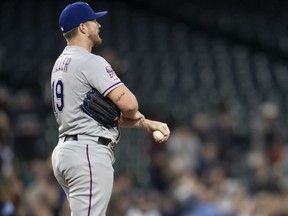 Texas Rangers starting pitcher Shelby Miller reacts after giving up a three-run home run to Seattle Mariners' Edwin Encarnacion that also scored Domingo Santana and Daniel Vogelbach during the third inning of a baseball game, Friday, April 26, 2019, in Seattle.