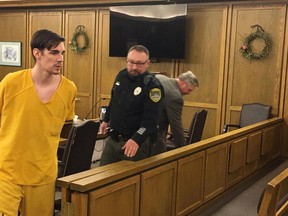 In this Friday, April 19, 2019, John A. Radavich, 24, left, is led back to jail after a hearing before Superior Court Judge Maryann Moreno in Spokane, Wash. The discovery of new evidence prompted a judge to declare a mistrial in the murder case against Radavich charged with killing the nephew of U.S. Sen. Jon Tester of Montana. The Spokesman-Review reports Friday, April 19, 2019, that court records show a sheriff's detective found a text message in the file while preparing to give testimony that hadn't been turned over to the defense. A new trial is set for August.