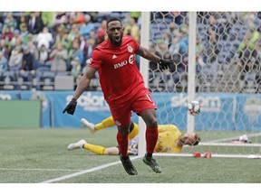 Toronto FC forward Jozy Altidore celebrates after he scored a goal against Seattle Sounders goalkeeper Stefan Frei, right, during the first half of an MLS soccer match, Saturday, April 13, 2019, in Seattle.