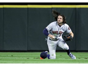 Houston Astros center fielder Jake Marisnick fields a two-RBI single hit by Seattle Mariners' Domingo Santana during the second inning of a baseball game, Friday, April 12, 2019, in Seattle.