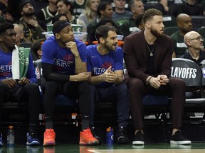 Detroit Pistons' Blake Griffin, right, watches from the bench during the first half of Game 1 of an NBA basketball first-round playoff series against the Milwaukee Bucks, Sunday, April 14, 2019, in Milwaukee.