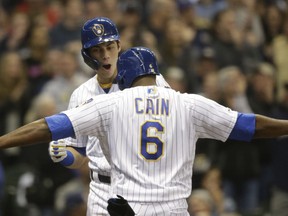 Milwaukee Brewers' Christian Yelich reacts with Lorenzo Cain (6) after his two-rim home run against the Los Angeles Dodgers during the first inning of a baseball game Friday, April 19, 2019, in Milwaukee.