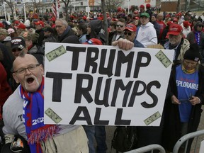 President Donald Trump supporter, Jammer Batzler. shows his support as he waits to get in to a rally to hear him speak Saturday, April 27, 2019, in Green Bay, Wis.