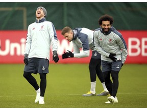 Liverpool's Alberto Moreno, left, and Mohamed Salah, right, react during a training session at Melwood training ground in Liverpool, England, Tuesday April 16, 2019. Liverpool will play Porto in their Champions League Quarter Final 2nd leg soccer match upcoming Wednesday.