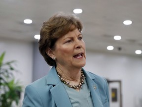 FILE - In this Oct. 6, 2018, file photo, Sen. Jeanne Shaheen, D-N.H., talks with a reporter on Capitol Hill in Washington. New Hampshire Democrats are looking for help from their party's presidential candidates in overturning a law they claim will make it harder for some college students to vote.