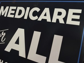 FILE - In this April 10, 2019 file photo, a sign is shown during a news conference to reintroduce  "Medicare for All" legislation, on Capitol Hill in Washington. The financial condition of the government's bedrock retirement programs for middle- and working-class Americans remain shaky, with Medicare pointed toward insolvency by 2026. That's the word from the latest report by the government's overseers of Medicare and Social Security, which paints a sobering picture of the programs, though it's relatively unchanged from last year's update. Social Security would become insolvent in 2035, one year later than previously estimated.