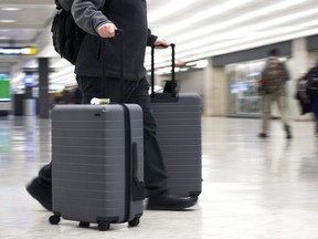 FILE - In this March 26, 2019, file photo, an airline passenger walk in the arrivals terminal at Dulles International Airport in Dulles, Va. Newly documents filed in a federal lawsuit claim that U.S. government searches of phones and laptops at airports are on the rise and are being conducted for reasons beyond immigration and customs enforcement. There were 33,295 searches in fiscal 2018.