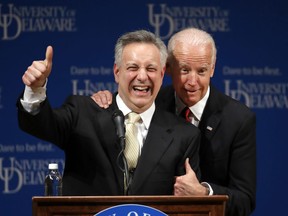 FILE - In this March 13, 2017, file photo, former Vice President Joe Biden, right, embraces University of Delaware President Dennis Assanis during an event to formally launch the Biden Institute, a research and policy center focused on domestic issues at the University of Delaware, in Newark, Del.
