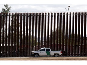 In this April 5, 2019, file photo, a U.S. Customs and Border Protection vehicle sits near the wall as President Donald Trump visits a new section of the border wall with Mexico in Calexico. Under pressure to show they have solutions, Democrats are honing proposals to address the surge of families entering the U.S. at the southern border, a problem they say Trump's restrictive immigration policies are enflaming.