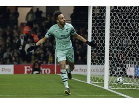 Arsenal's Pierre-Emerick Aubameyang celebrates after scoring the opening goal during the English Premier League soccer match between Watford and Arsenal at Vicarage Road stadium in Watford, England, Monday, April 15, 2019.