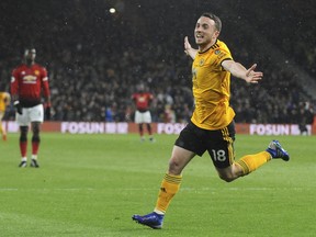 Wolverhampton's Diogo Jota celebrates after scoring his side's first goal during the English Premier League soccer match between Wolverhampton Wanderers and Manchester United at the Molineux Stadium in Wolverhampton, England, Tuesday, April 2, 2019.