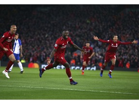 Liverpool's Naby Keita, center, celebrates after scoring the opening goal during the Champions League quarterfinal, first leg, soccer match between Liverpool and FC Porto at Anfield Stadium, Liverpool, England, Tuesday April 9, 2019.