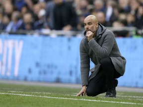 Manchester City coach Pep Guardiola watches from the touchline during the English FA Cup semifinal soccer match between Manchester City and Brighton & Hove Albion at Wembley Stadium in London, Saturday, April 6, 2019.