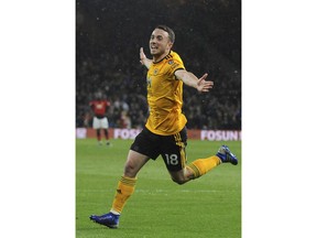 Wolverhampton's Diogo Jota celebrates after scoring his side's first goal during the English Premier League soccer match between Wolverhampton Wanderers and Manchester United at the Molineux Stadium in Wolverhampton, England, Tuesday, April 2, 2019.