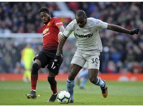 Manchester United's Fred vies for the ball with West Ham's Michail Antonio, right, during the English Premier League soccer match between Manchester United and West Ham United at Old Trafford in Manchester, England, Saturday, April 13, 2019.